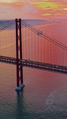  Aerial view of 25 de Abril bridge over the Tagus River at sunset in Lisbon, Portugal