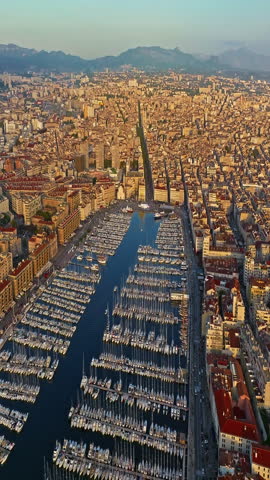 Aerial view of the city of Marseille in the morning sun. Rooftops in French Town. Crowds of people stroll through the coastal town. Drone view of Marseille in the south of France