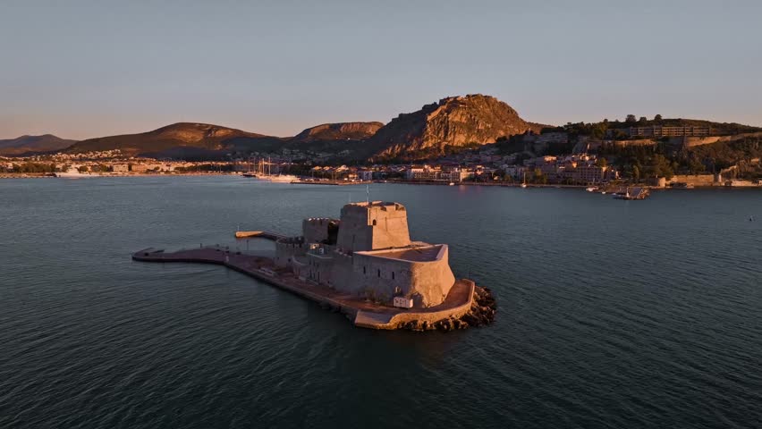 Aerial view of the Bourtzi castle and Palamidi mountain along the coast with the city visible in the background, Nafplion, Argolis, Greece.