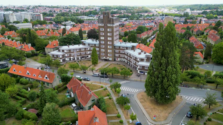 Aerial view of orange rooftops contrast with green trees and manicured lawns near Joseph Wauters Place, Watermael-Boitsfort, Brussels, Belgium.