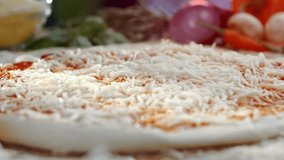 Close-up view of fresh sliced mushrooms falling onto a raw pizza base covered with tomato sauce and grated mozzarella cheese, showing the preparation of a traditional italian dish - Powered by Shutterstock - Get 15% off with code: PIKWIZARD15