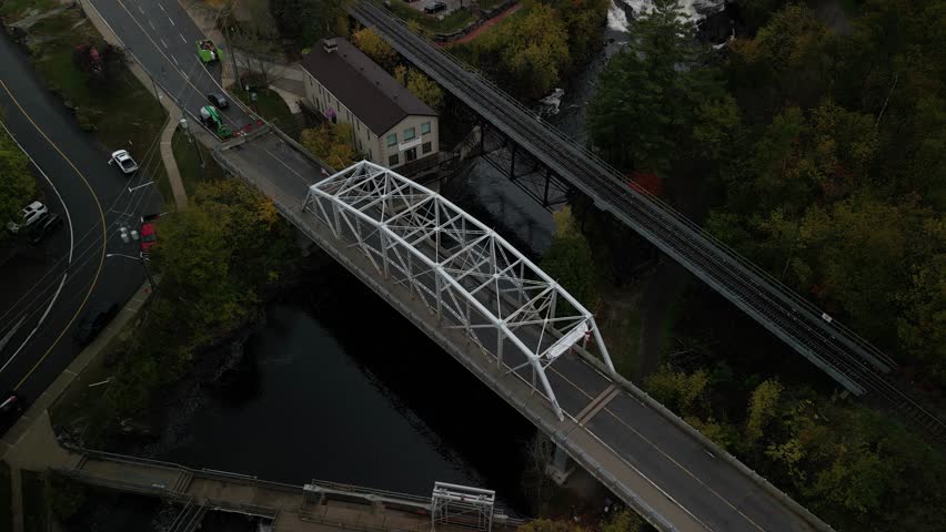 Aerial above Bracebridge Ontario Canada Muskoka River and train track and bridge in fall