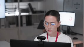 Young Asian call center woman wearing headset and microphone while working at computer in modern office. Professional customer support representative providing online assistance, technical help - Powered by Shutterstock - Get 15% off with code: PIKWIZARD15