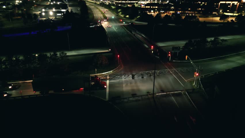 Aerial View Highlights Nighttime Traffic Interchange In Dartmouth Nova Scotia Canada. Bright Car Headlights And Tail Lights Form Patterns Of Light Against The Deep Shadows Of Night.