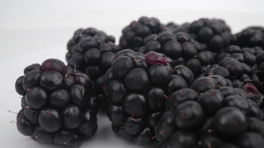 Close-up Look at Freshly Picked Blackberries Pile on a White Surface