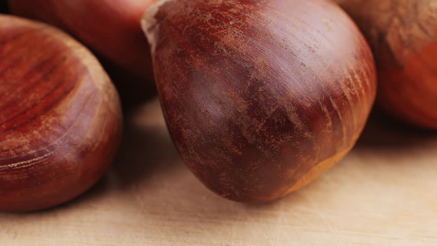 Fresh chestnut, supermarket food, Oven roasted chestnuts with sliced peel on wooden board, spanish traditional winter dish.