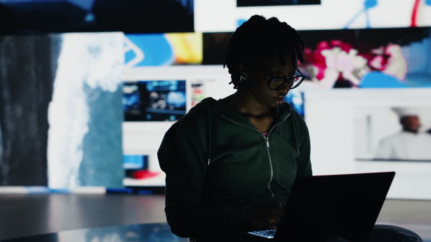 Young woman addicted to watching internet clips, unable to stop using notebook. Lazy teenager staring at laptop display, concept of technology overuse and digital dependence