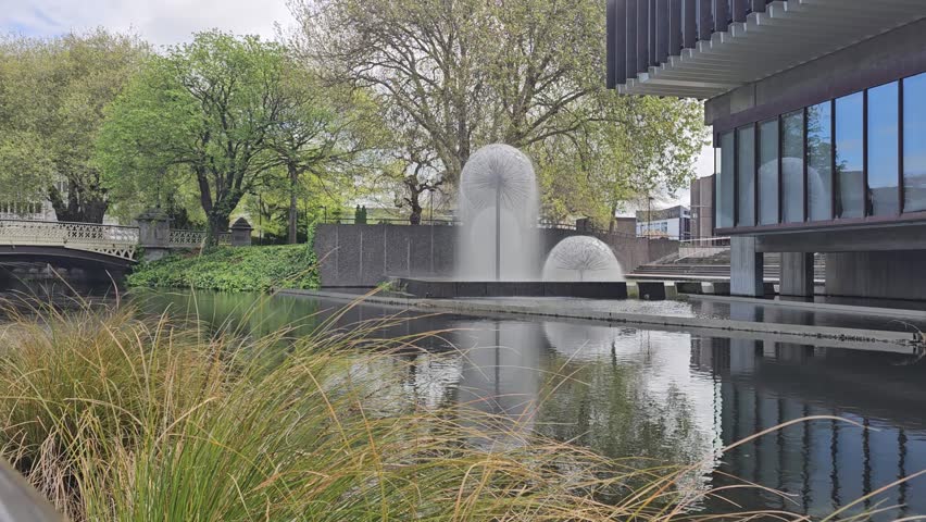 A still video capturing the dandelion-style fountain in downtown Christchurch, New Zealand. Water sprays gracefully from the sculptural spheres shimmering in the sunlight while reflecting on the river
