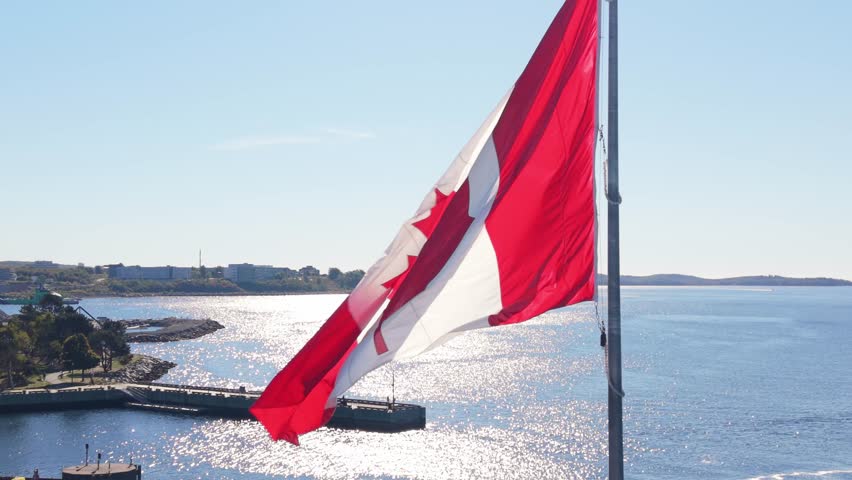 Cinematic Aerial View Dramatic Drone Footage Of Canada Flag Flying Above Halifax, Nova Scotia, Canada. A Symbolic Scene Highlighting National Pride Amidst The Modern Cityscape And Maritime Spirit.