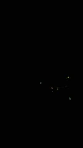 Night storm on Caribbean beach with lightning, rain, strong wind, and rooftops near Coveñas, Colombian coast