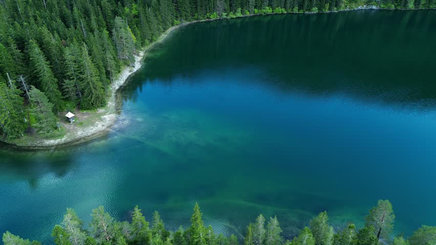 Aerial of Black Lake, a glacial lake, Durmitor National Park surrounded by dense coniferous forests