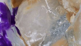 Vertical video. Splatter ink. Ice art. Defocused purple white yellow color sparkling texture liquid pour on golden frost light abstract background. - Powered by Shutterstock - Get 15% off with code: PIKWIZARD15