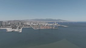 D-Log M. Izmir, Turkey.Aerial view of Izmir Port container terminal with stacking area and large cranes for cargo operations on sunny summer day. Aerial view. - Powered by Shutterstock - Get 15% off with code: PIKWIZARD15