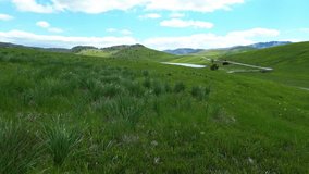 Aerial closeup of beautiful green grasslands with a backdrop of rocky mountains in Durmitor National Park on Jezerska plateau, Vrazje jezero glacial lake, Revealing shot - Powered by Shutterstock - Get 15% off with code: PIKWIZARD15