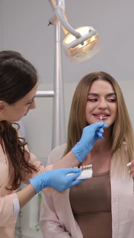 A dentist offers valuable help with smile assessment and precise color matching for cosmetic work