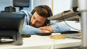 Animation of digital icons and data processing over caucasian man sleeping on his desk at office. Computer interface and business technology concept - Powered by Shutterstock - Get 15% off with code: PIKWIZARD15