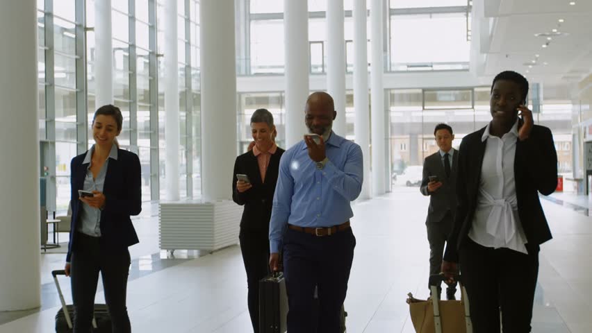 Animation of connected icons with lines, diverse coworkers with phone and luggage walking at airport. Digital composite, multiple exposure, communication, business travel and teamwork concept. - Powered by Shutterstock - Get 15% off with code: PIKWIZARD15