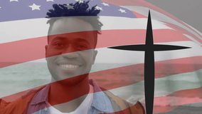 Animation of flag of america and cross over portrait of smiling african american man against sea. Digital composite, multiple exposure, symbol, religious, christianity, nature, identity, patriotism. - Powered by Shutterstock - Get 15% off with code: PIKWIZARD15