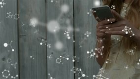 Woman tapping smartphone by plank fence, drawing nodes into pulsing security padlock animation. Technology, cybersecurity, digital network, data protection, minimalism, outdoor, modern - Powered by Shutterstock - Get 15% off with code: PIKWIZARD15