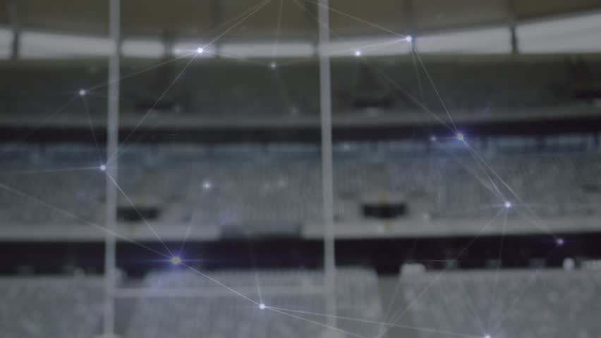 Network nodes pulsing and drifting, rugby ball emerging on red tee highlighting kick spot on field. Stadium, sports, athletic, technology, network, digital, competition - Powered by Shutterstock - Get 15% off with code: PIKWIZARD15