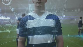 Rugby player standing center field activating data overlay showing metrics with teammates warming. Athlete, performance, analytics, digital, teamwork, stadium, sports - Powered by Shutterstock - Get 15% off with code: PIKWIZARD15