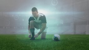 Rugby player kneeling tying cleats triggers lines swirling lifting ball then jogging for kickoff. Athlete, sports, motion, equipment, competition, stadium, digital - Powered by Shutterstock - Get 15% off with code: PIKWIZARD15