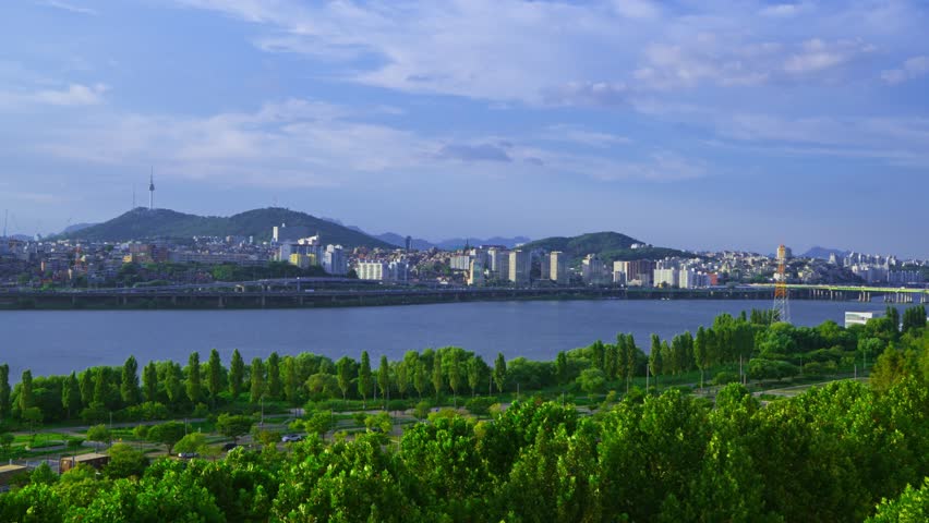 Aerial view of the green Hangang Park, Han River and the Seoul city skyline with Namsan Tower on a bright sunny summer day