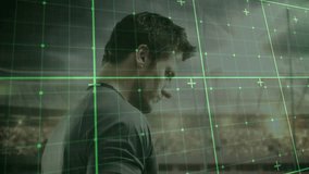 Male athlete holding white oval ball in sports stadium, grid overlay fading while preparing kick. Athlete, stadium, digital overlay, sports, competition, action, focus - Powered by Shutterstock - Get 15% off with code: PIKWIZARD15