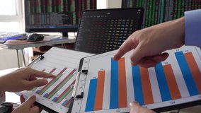 Chinese stock traders discuss market trends and financial data in a modern office, highlighting teamwork, investment, and business analysis. - Powered by Shutterstock - Get 15% off with code: PIKWIZARD15