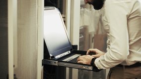 System Engineer Control Room IT Administrator. Server Engineer Work On Laptop in Data Center. Male Server IT Engineer Work Data Center. Man Work In Server Room. Male Typing On Laptop In Server Room - Powered by Shutterstock - Get 15% off with code: PIKWIZARD15