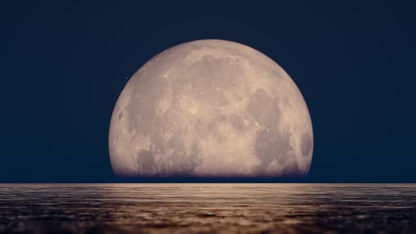 The moon rises over the sea during the Mid-Autumn Festival on August 15th, creating a serene and festive night scene celebrating tradition and lunar beauty.