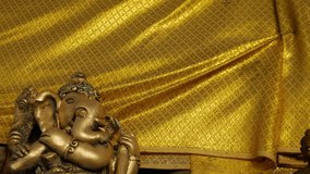 Bronze Ganesha Statue with Golden Cloth at Hindu Temple - Elephant God Holding Musical Instrument - Powered by Shutterstock - Get 15% off with code: PIKWIZARD15