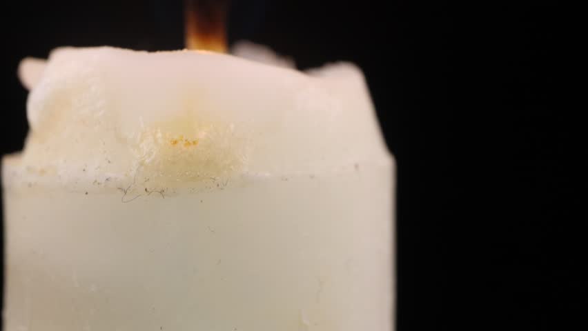 Timelapse white candle melting with dripping wax and burning flame, time lapse candlelight concept for passage of time, transformation, meditation ambiance and peaceful illumination - Powered by Shutterstock - Get 15% off with code: PIKWIZARD15