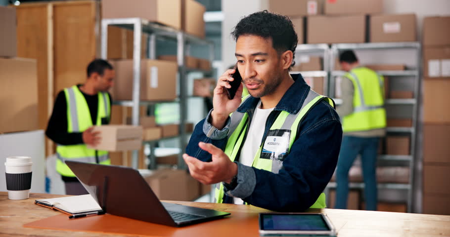 Logistics, phone call and tablet with man in warehouse for delivery, distribution or shipping. App, laptop and online order with supply chain employee in export or import depot for parcel tracking