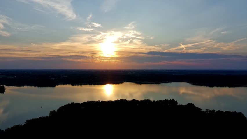 Sunrise over a lake in Missouri on a warm autumn day, calm water