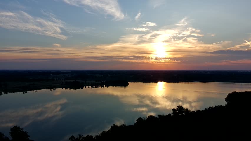 Sunrise over a lake in Missouri on a warm autumn day, calm water