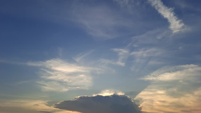 Peaceful sunset over a traditional salt farm, glowing in warm orange and red hues, with calm reflections and beautiful clouds painting the serene evening sky.