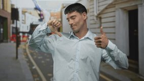 Man makes opposing thumbs up and thumbs down gestures on an urban street scene with blurred buildings; indecision. - Powered by Shutterstock - Get 15% off with code: PIKWIZARD15