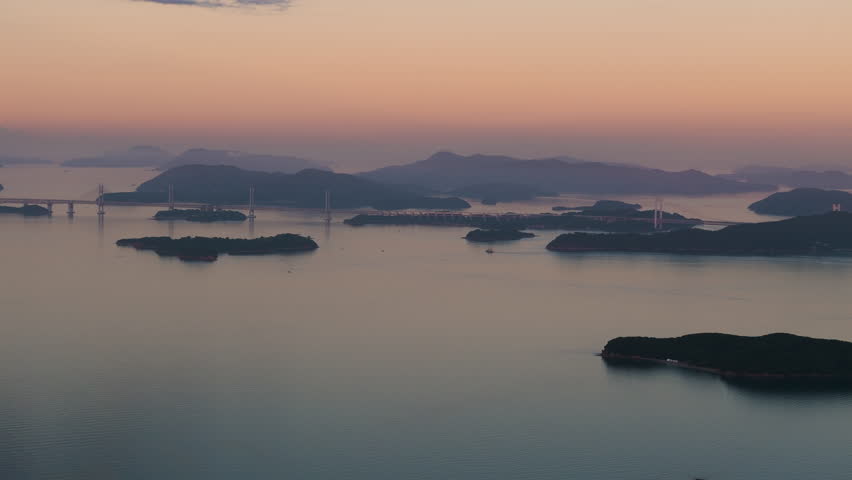 Cinematic aerial shot of sunrise at Seto inland sea in Hiroshima prefecture, Japan