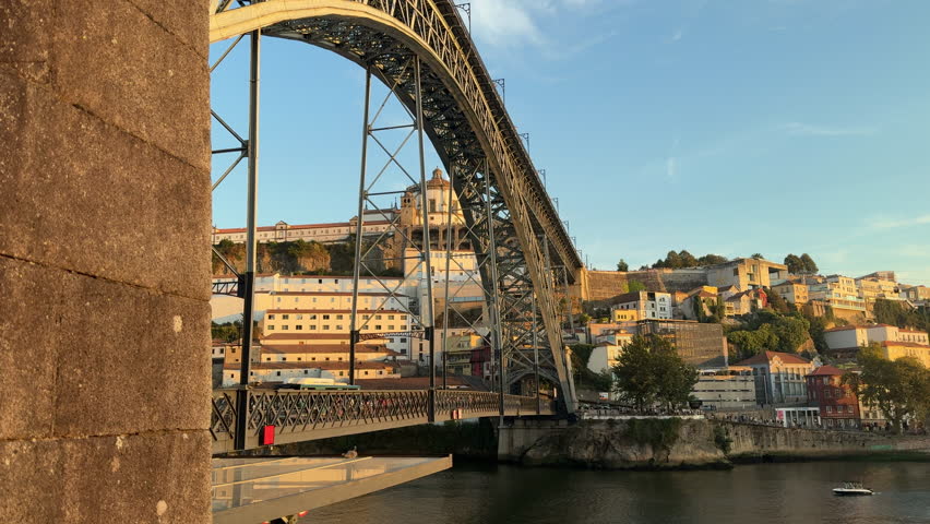 Shot of the iconic Dom Luís I Bridge stretching over the Douro River in Porto, Portugal.