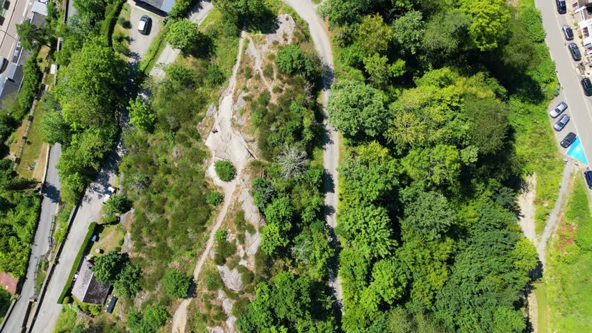 Aerial view of the medieval La Roche-en-Ardenne Castle sitting majestically amidst lush greenery and quaint town buildings, La Roche-en-Ardenne, Wallonia, Belgium.