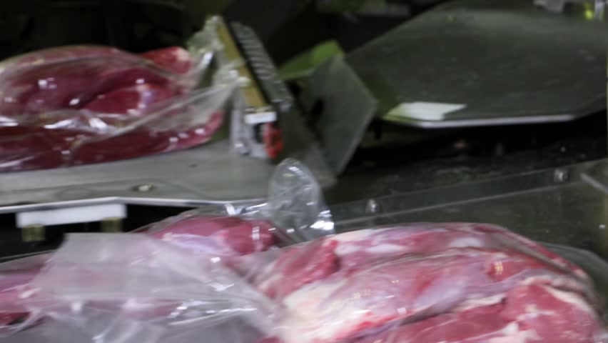 meat processing facility, conveyor belt, for packaging and further processing, factory inside large abattoir