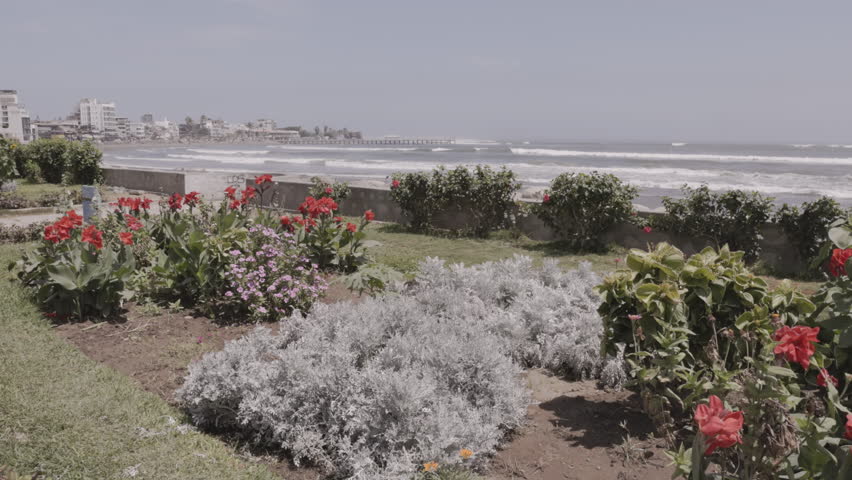 a wide shot of the pier and waterfront of the popular seaside town of huachaco, peru