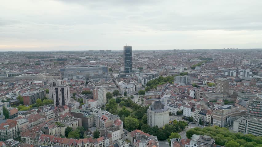 Aerial view of Brussels reveals an urban tapestry of buildings and towers under a cloudy sky, Bruxelles, Brussels, Belgium.