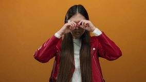 Woman expressing surprise against vibrant orange background wearing red jacket with long hair and neutral expression, isolated, adult, asian, female, chinese person. - Powered by Shutterstock - Get 15% off with code: PIKWIZARD15