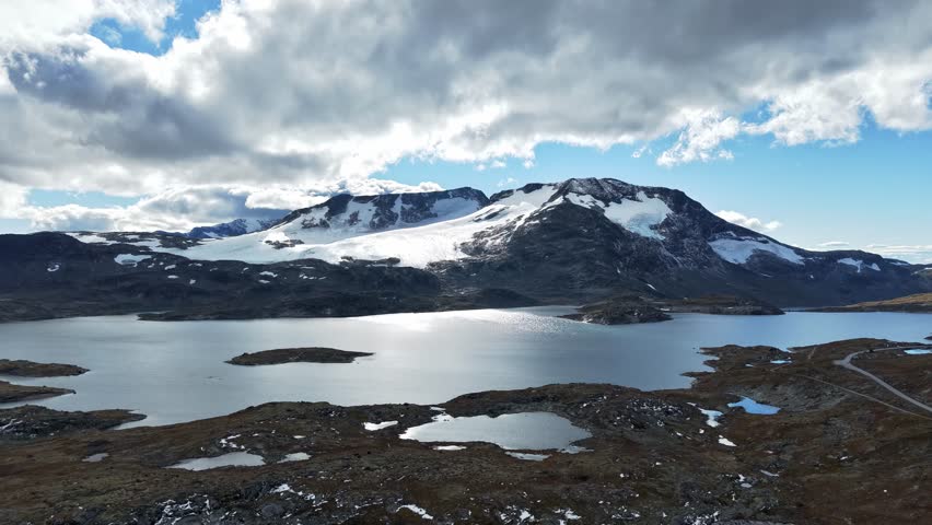 Timelapse of fast moving clouds over snow covered mountains in Jotunheimen National Park