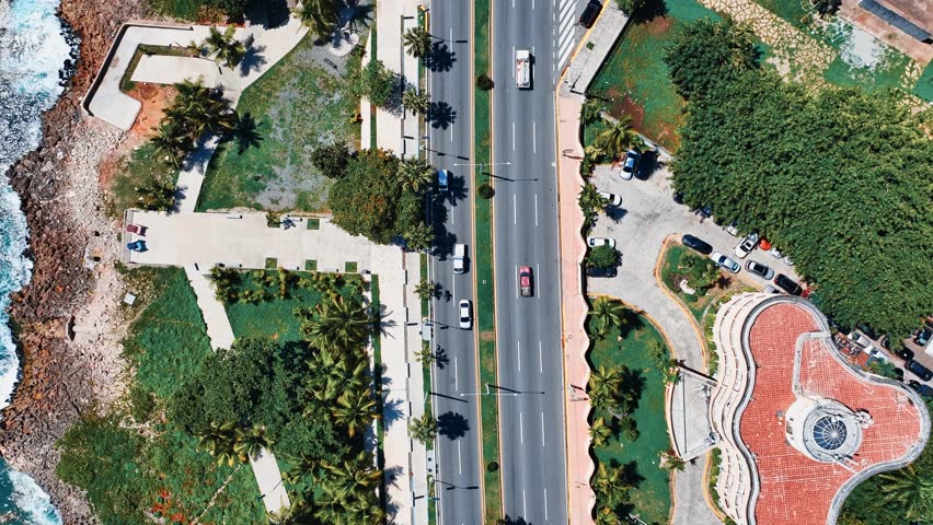 Urban highway along the coastline. Summer road landscape. Pleasant drive along the coastal highway. Traveling through Santo Domingo along a beautiful road by the sea in the Dominican Republic.