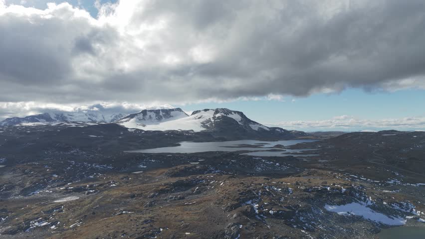 Dramatic areal footage of fast moving clouds, mountains and glaciers in Jotunheimen National Park, Norway