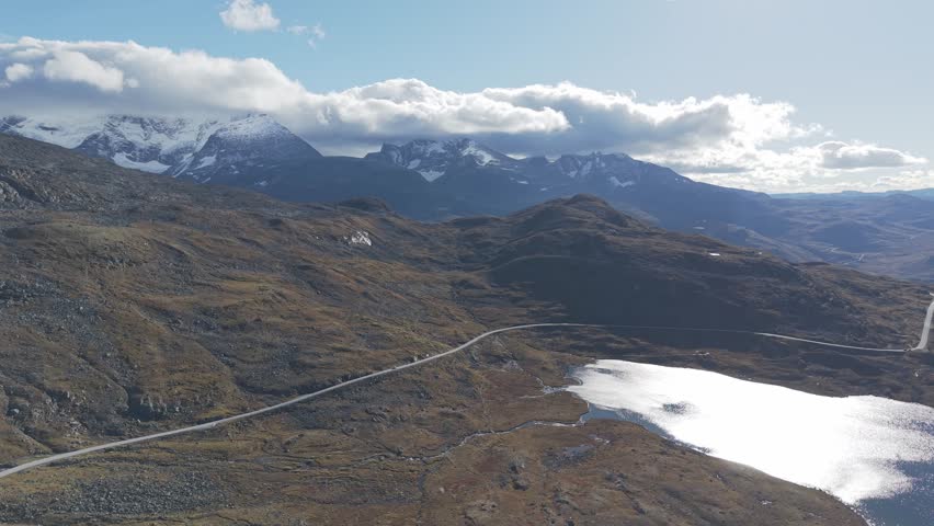 Panorama view of a National scenic route in Norway going over mountains. Areal footage