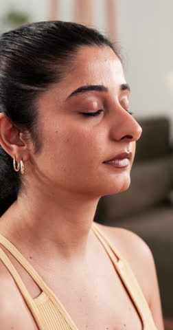 Breathing, woman and mindfulness in lounge, meditation and yoga for self awareness in house and zen. Calm, person and routine for wellness, break and healthy in living room, exhale or inner peace